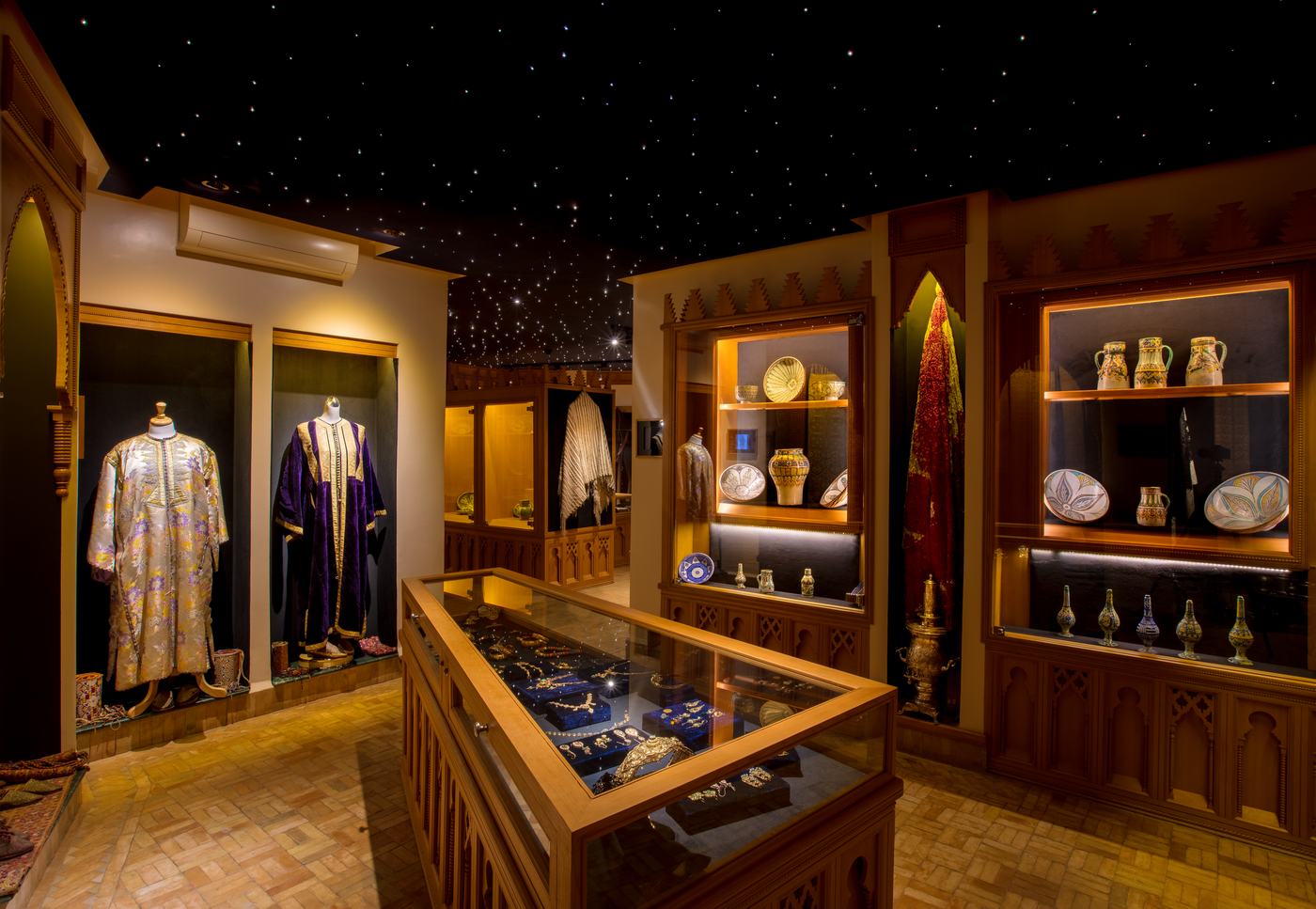 Caftans and crafts displayed under a starlit ceiling